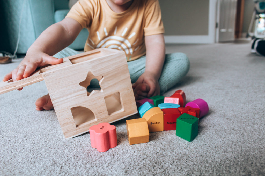 aidan playing with wooden toys